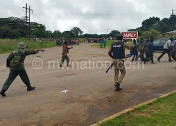 Police and army instructing protesters to clear the M1 Road