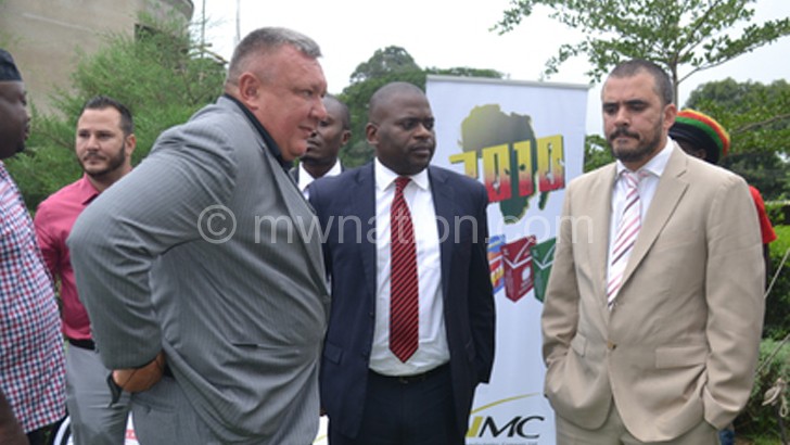 Buckle (L), Kalaitzis (R) and Bullets former chairperson Samuel Chilunga interact during the  partnership agreement launch