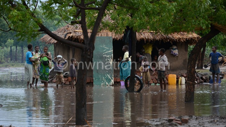 Flashback: A family waits outside their home for relief teams in 
Chikwawa, during the January 2015 floods