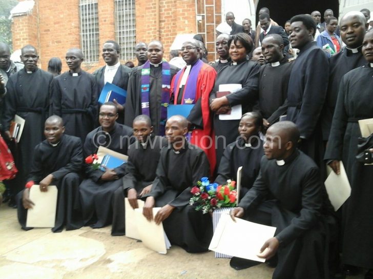 Phiri (in red gown) poses with the ordinands