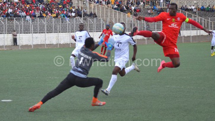 Brace hero: Msowoya (R) flicks the ball over Makina to score his second goal