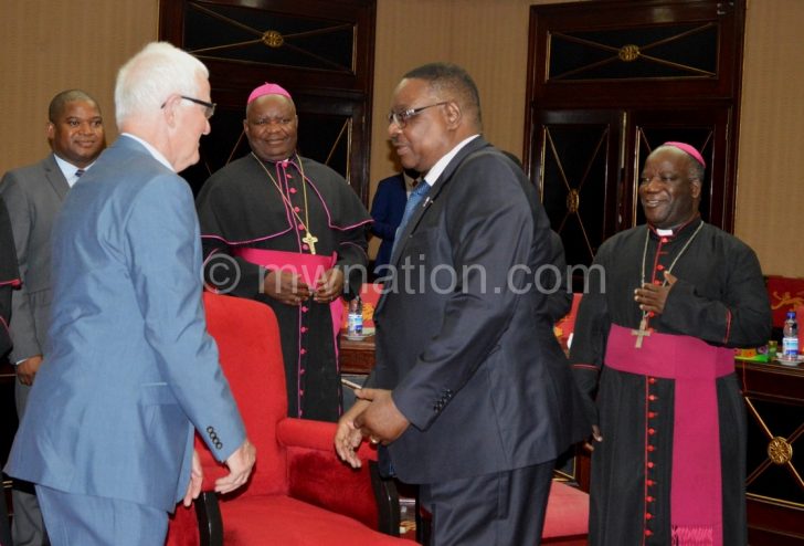 Mutharika greets Ryan during a recent meeting with Catholic
Bishops at Kamuzu Palace