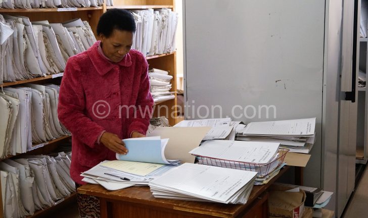 A court clerk sifting through files in the registry