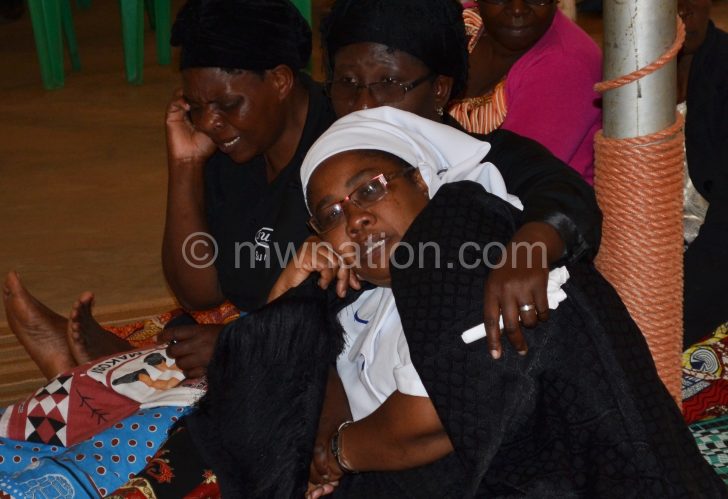 Mbendera’s widow being consoled