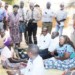 Parliamentary Committee on Social and Community Affairs members interact with a SCTP beneficiary Litiness Levison in Mchinji