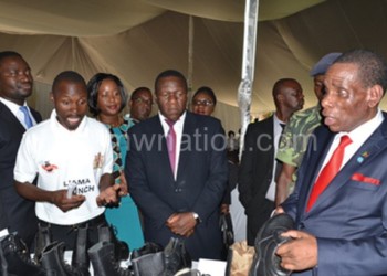 Mwanamvekha (R) appreciates leather products prior to Liama launch