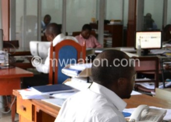 Workers carry out respective duties in an office