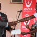 Namadingo getting a cheque from Macra deputy Director General Francis Bisika