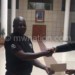 Namadingo (R) receiving a contribution from the MPs 
through Werani Chilenga (C)