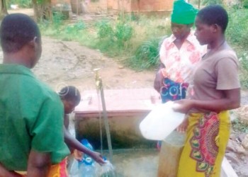 Women draw water at Lukono Village inside the disputed territory