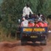A lorry carries people and goods to Thambani