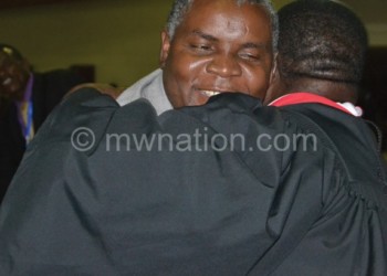 Maulana (back to camera) hugs Mbolembole on his victory