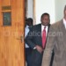 Chaponda (in red necktie) getting out of the court yesterday