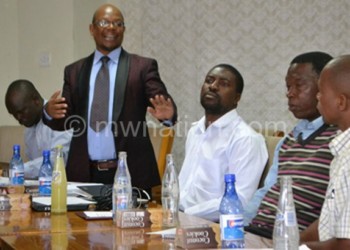 Mwanza (standing) commenting on the findings 
during the Blantyre meeting