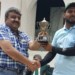 Cricketer Mehmood receives the trophy from Bheda representative Shabbir Bheda