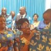 Bikoko is wrapped in DPP cloth as he is welcomed by Jeffrey while Jean Kalilani (L) and other DPP supporters look on