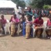 Students beating drums during the event