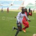 Nomads (in white) and Masters players fight for ball possession