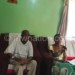 Bombeya and wife (seated) 
listen to Msonkho