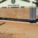 A pupil walks past a classroom block 
constructed by AP at Mpondagaga CDSS