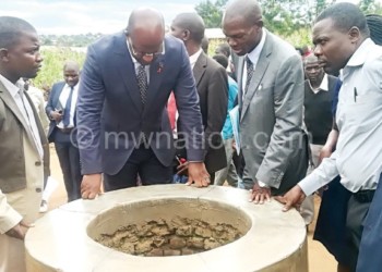 Muluzi inspects one of the shallow wells in Mitengo