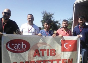 Attib Amstetten members display their banner after donating items