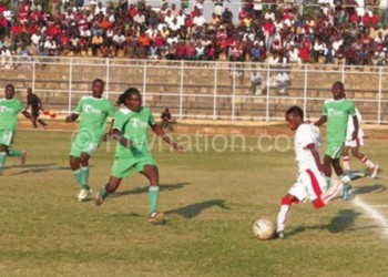 Mponela (in green) battling it out against Big Bullets in Super League