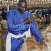 An AHL group employee stitches tobacco bales at Kanengo Auction Floors in Lilongwe