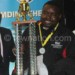 Mwale (C) receives his trophy from Kamwendo (L) as Chipofya looks on