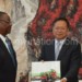 Wang (R) receives a gift from Mutharika