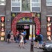 Money maker: Tourists to Amsterdam cannot resist the allure of De Wallen, a popular Red Light District