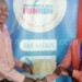 NPL marketing assistant Suzgo Mwantisi (L) receives the money from Howa