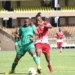 Malawi’s John Lanjesi (L) tries to block Kenya’s goal scorer Francis Kahata