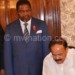 Naidu (R) signs the visitors’ book at Kamuzu Palace in Lilongwe as Minister of Education Bright Msaka (C) and India govt official look on