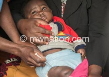 A healthcare worker jabs a child with
newly-introduced malaria vaccine