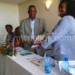 Kathewera (R) hands over the manifesto to Sibande