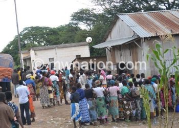 People queue at an Admarc depot to buy maize
