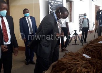 Kasaila appriciates tobacco quality during the official opening of the market