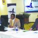 Mwadiwa (C) speaks during the AGM flanked by PCL Group chief executive officer George Partridge (R) and company secretary Bernard Ndau