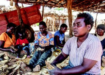 Women shell maize in the Malembo Village in Lilongwe, the birthplace of Chakwera