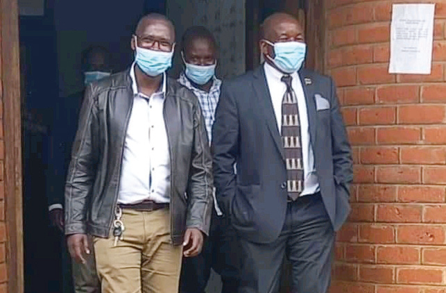 Msukwa (R) and well-wishers walk out of court
during one of his appearnces