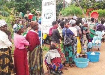 Women wait for their turn during a previous maize shortage experience