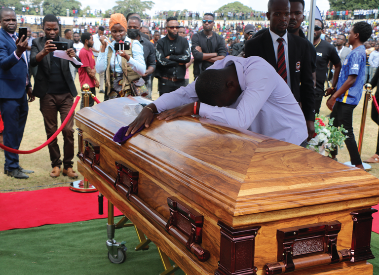 A grief-stricken relative embraces a casket carrying Martse’s remains