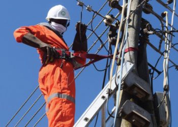 An Escom technician connects a customer to the national grid