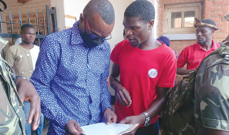 Gwedemula (L) receives petition from Bondo