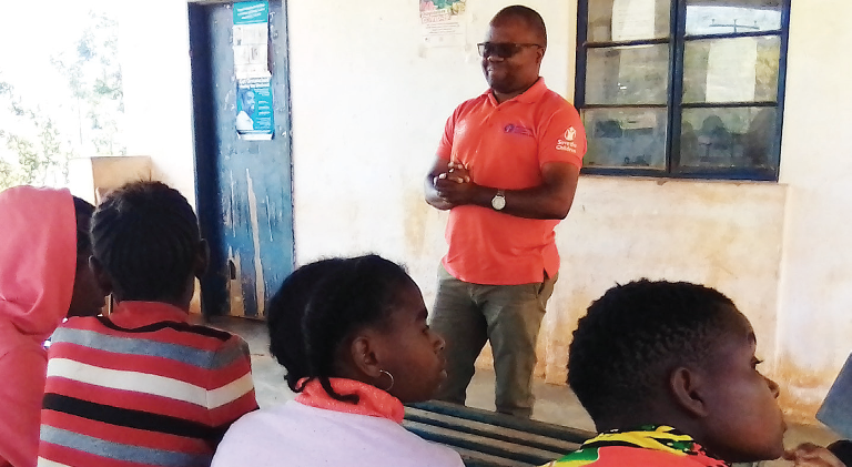 Stephano addresses the adolescent girls in Bangwe