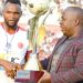 Chimwendo Banda (R) presents the cup to Bullets captain John Lanjesi