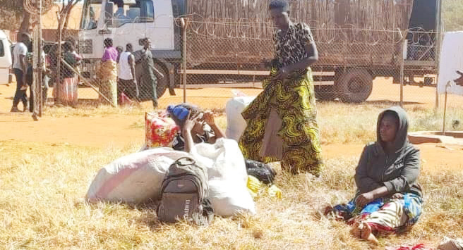 Some women rounded up in Blantyre languish in the sun waiting
to be allocated a tent at Dzaleka Refugee Camp