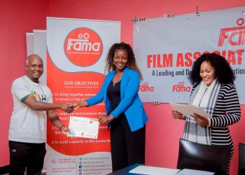 Sukali (L) presents a certificate of participation to Chisale as veteran actress Joyce Mhango-Chavula looks on