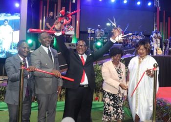 President Chakwera (C) gestures after cutting the ribbon to launch the book